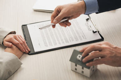 man and woman reviewing a real estate contract