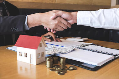 Real estate buyer and seller shaking hands