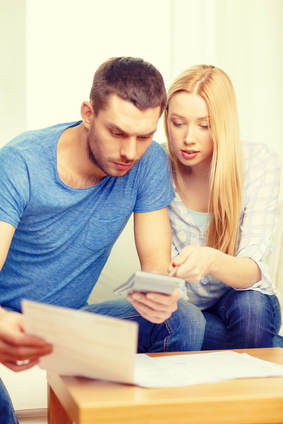 Couple figuring out mortgage loan costs
