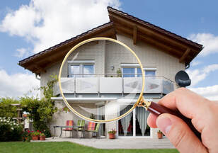 Magnifying glass over house